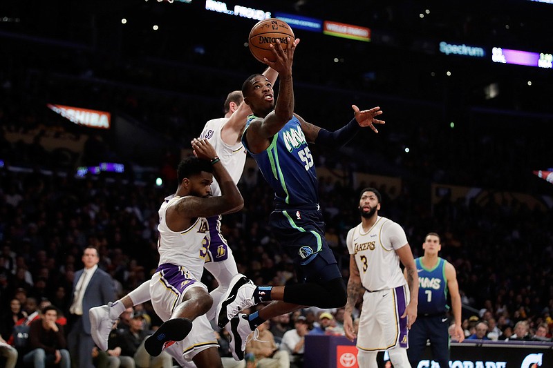 Dallas Mavericks' Delon Wright (55) drives to the basket against the Los Angeles Lakers during the second half Sunday in Los Angeles. 