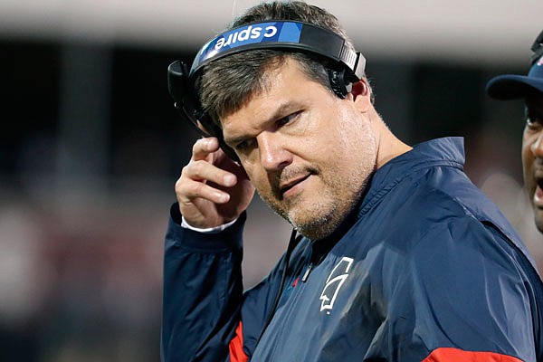 Mississippi head coach Matt Luke removes his headset during Thursday's game against Mississippi State in Starkville, Miss. Mississippi fired Luke on Sunday, three days after his third non-winning season ended with an excruciating rivalry game loss in the Egg Bowl to the Bulldogs.