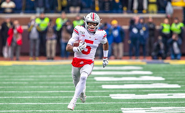 Ohio State wide receiver Garrett Wilson gains 47 yards after a reception in the second quarter of Saturday afternoon's game against Michigan in Ann Arbor, Mich.