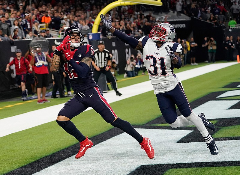Houston Texans wide receiver Kenny Stills (12) pulls in a pass in front of New England Patriots cornerback Jonathan Jones (31) for a touchdown during the second half of an NFL football game Sunday, Dec. 1, 2019, in Houston. (AP Photo/David J. Phillip)