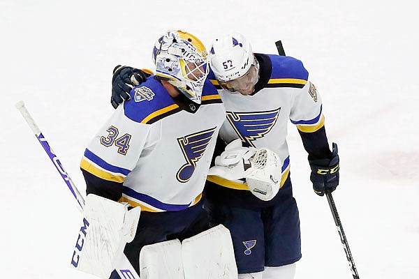 Blues goaltender Jake Allen is congratulated by teammate David Perron after Monday night's 4-0 victory against the Blackhawks in Chicago.