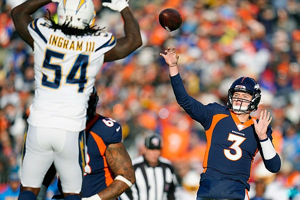 Broncos quarterback Drew Lock passes under pressure from Chargers defensive end Melvin Ingram during Sunday's game in Denver.