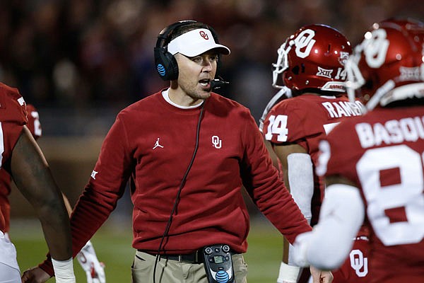 Oklahoma coach Lincoln Riley greets players as they return to the sideline after scoring in the first half of a game last month against TCU in Norman, Okla.