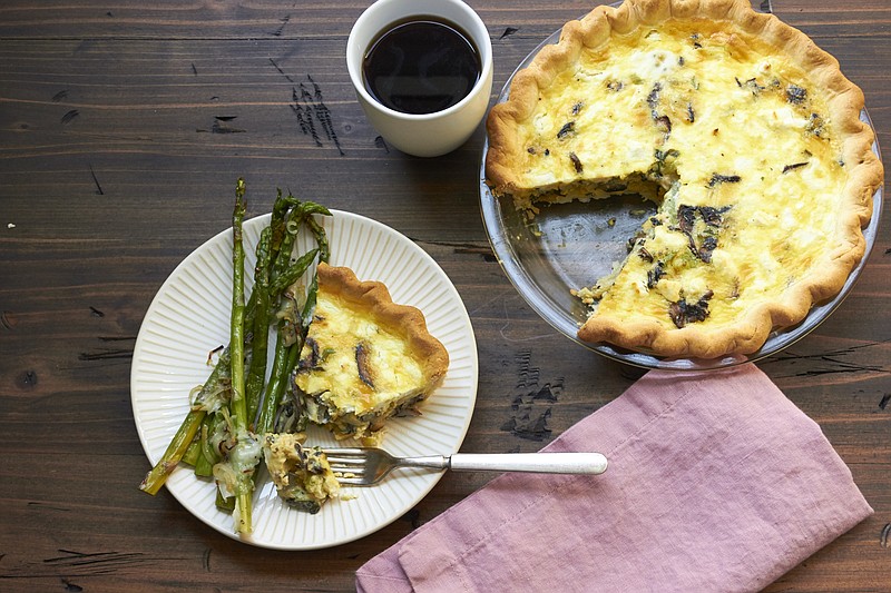 This April 2018 photo shows a leek, mushroom and goat cheese quiche in New York. Setting out breakfast for your guests to help themselves to when they wake up in the morning is a low-stress, make ahead way for you to offer the morning meal. (Mia/Katie Workman via AP)