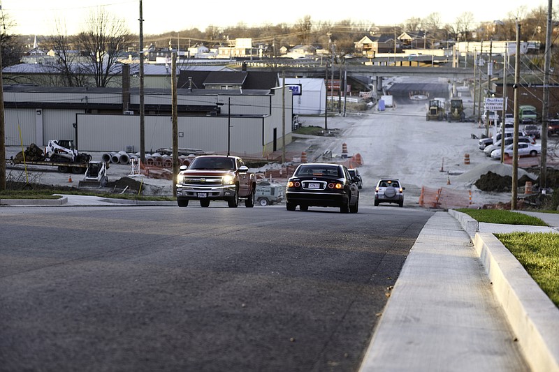 Cars drive on West Dunklin Street on Tuesday after the city reopened the 300-500 blocks of the street, though construction will continue through the winter replacing a bridge and making stormwater repairs.