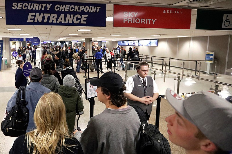  In this Wednesday, Nov. 27, 2019, file photo, travelers walk through a security checkpoint in Terminal 2 at Salt Lake City International Airport, in Salt Lake City. Federal officials are considering requiring that all travelers, including American citizens, be photographed as they enter or leave the country as part of an identification system using facial-recognition technology. (AP Photo/Rick Bowmer, File)
