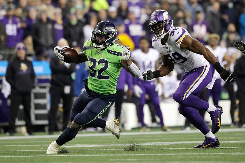 Seattle Seahawks' Chris Carson runs on a 26-yard carry as Minnesota Vikings' Danielle Hunter pursues during the second half of an NFL football game, Monday, Dec. 2, 2019, in Seattle. (AP Photo/Ted S. Warren)