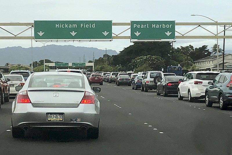 Traffic backs up at the main gates after a shooting at Pearl Harbor Naval shipyard, Wednesday, Dec. 4, 2019, near Pearl Harbor in Honolulu. (AP Photo/Caleb Jones)