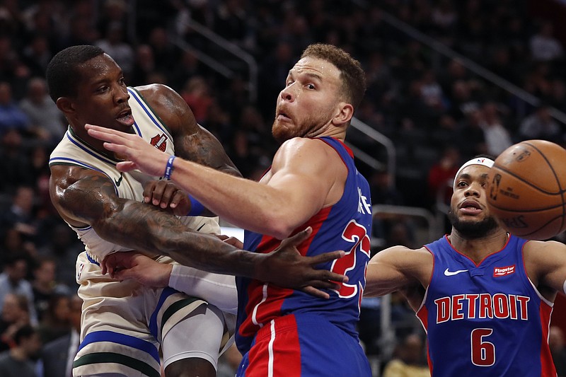 Milwaukee Bucks guard Eric Bledsoe passes around Detroit Pistons forward Blake Griffin (23) during the first half of an NBA basketball game, Wednesday, Dec. 4, 2019, in Detroit. (AP Photo/Carlos Osorio)