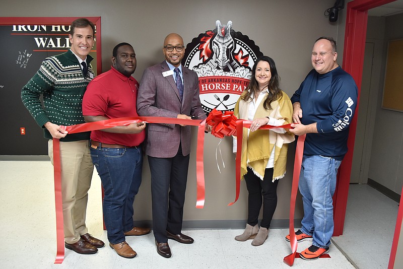 The University of Arkansas Hope-Texarkana held a grand opening of the Iron Horse Pantry on Monday on the Hope campus. Shown, from left, are Chris Thomason, UAHT chancellor; Kristaryon Easter, UAHT Student Government Association president; Dr. Christopher Smith, UAHT dean of student services; Camille Wrinkle, Harvest Regional Food Bank executive director; and Douglas Deitz, Harvest Regional Food Bank agency relations and programs director. (Submitted photo)


