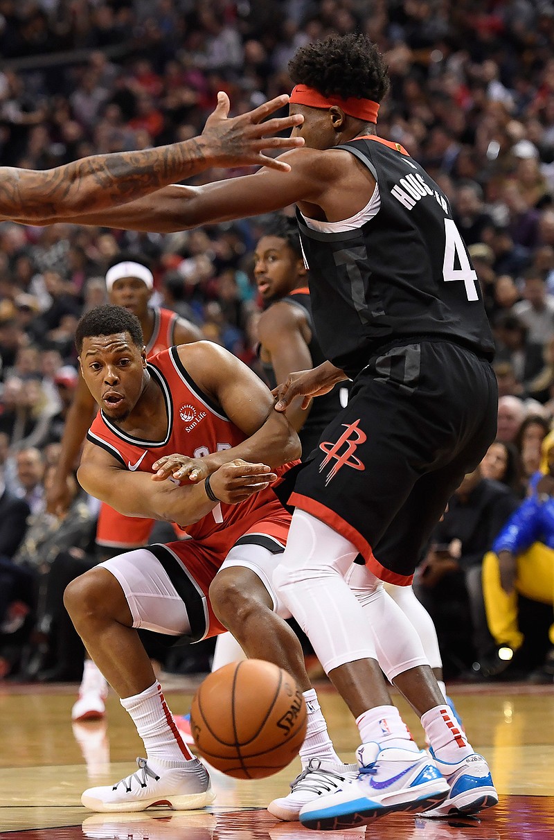 Toronto Raptors guard Kyle Lowry (7) passes the ball past Houston Rockets forward Danuel House Jr. (4) during first half NBA action in Toronto on Thursday, Dec.5, 2019. (Nathan Denette/The Canadian Press via AP)