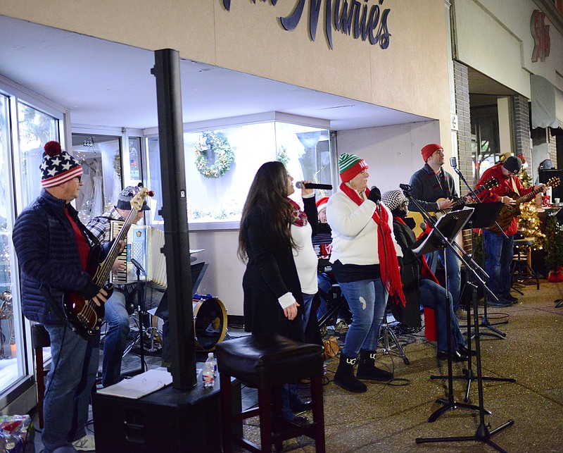 Sally Ince/News TribuneThe Solid Rock Church Band performs Friday outside of Ana Marie's during the Downtown Living Windows event.