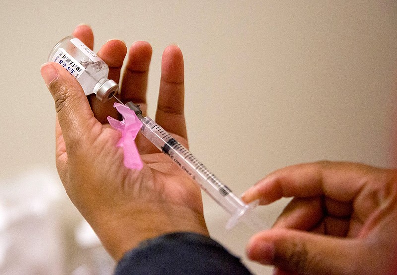 In this Feb. 7, 2018, file photo, a nurse prepares a flu shot at the Salvation Army in Atlanta. (AP Photo/David Goldman)