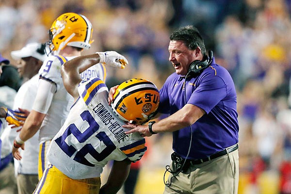 LSU coach Ed Orgeron celebrates with running back Clyde Edwards-Helaire after a touchdown during last Saturday's game against Texas A&M in Baton Rouge, La.