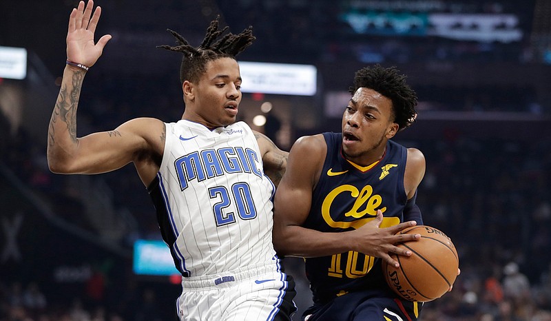 Cleveland Cavaliers' Darius Garland (10) drives past Orlando Magic's Markelle Fultz (20) in the first half of an NBA basketball game, Friday, Dec. 6, 2019, in Cleveland. (AP Photo/Tony Dejak)