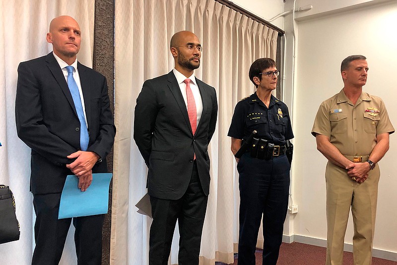 Left to right, NCIS Special Agent Norman Dominesey, U.S. Attorney for Hawaii Kenji Price, Honolulu Police Chief Susan Ballard and Rear Adm. Robert Chadwick, the commander of Navy Region Hawaii, listen during a news conference Friday, December 6, 2019, about the Pearl Harbor Naval Shipyard shooting. The U.S. Navy sailor who fatally shot two people at Pearl Harbor before killing himself was unhappy with his commanders and had been undergoing counseling, a military official said Friday. (AP Photo/Jennifer Sinco Kelleher)
