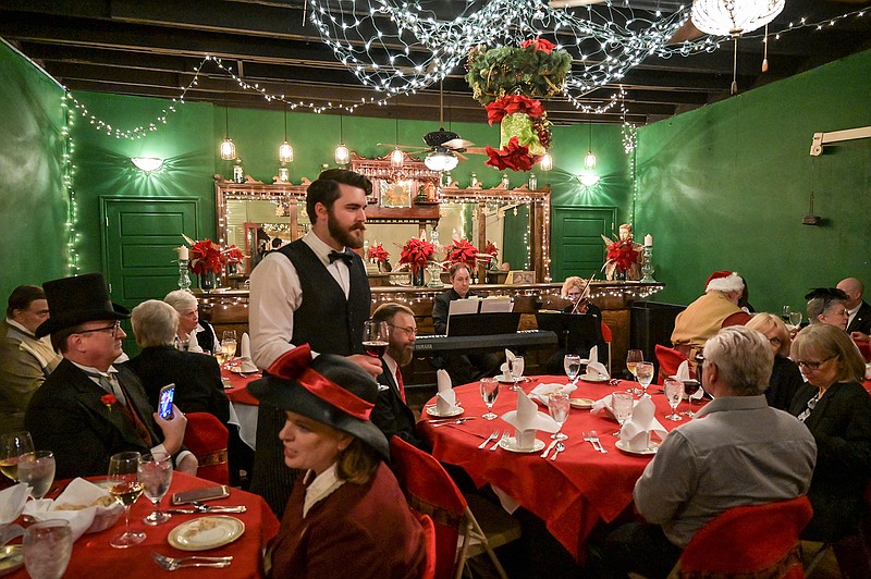 Waiters serve drinks to guests at the Edwardian Progressive dinner Thursday at Texarkana's Old Town upstairs in the Lindsey Railroad Museum in Texarkana, Ark. Guests were encouraged to dress during the Edwardian Era of fashion and were served a three course meal while being entertained by chamber music throughout the dinner.