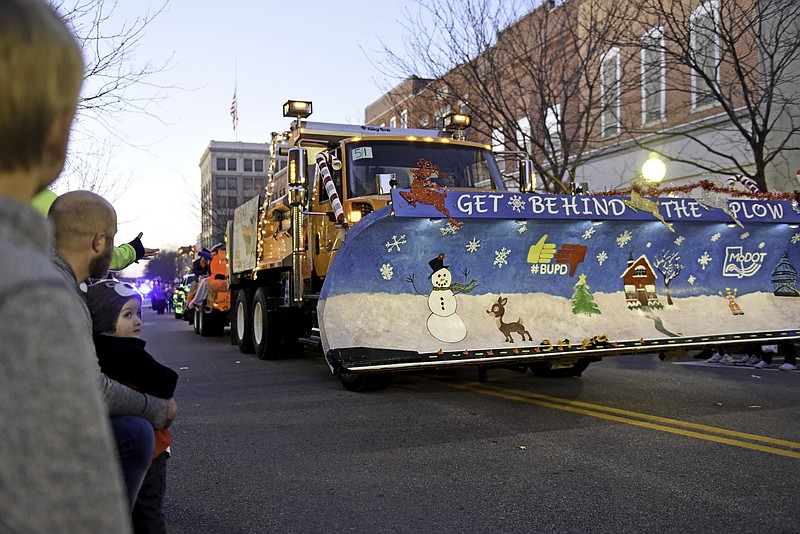 FILE: A decorated snow plow comes down the street at the 80th Annual Jefferson City Jaycees Candyland Christmas Parade on Saturday, December 7, 2019 in Jefferson City. The plow pulled a trailer of people sitting on hay behind it.