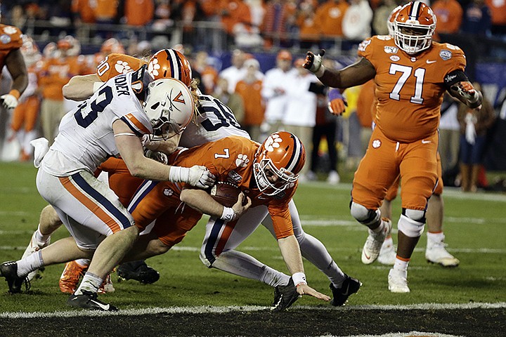 Clemson quarterback Chase Brice (7) scores a touchdown against Virginia during the second half of the Atlantic Coast Conference championship NCAA college football game in Charlotte, N.C., Saturday, Dec. 7, 2019. Clemson won 62-17. (AP Photo/Gerry Broome)