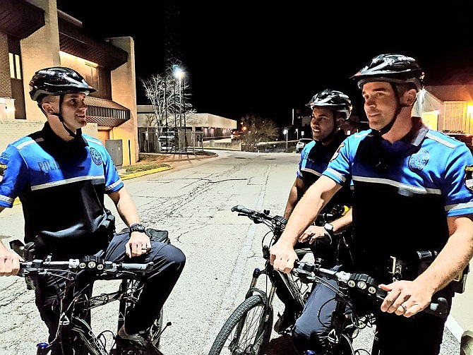 Jefferson City Police Department officers John Lehman, Tommy Barron and Jake Schnakenberg discuss plans before heading out to ride as part of the department's bike patrol Thursday. The bike patrol has been up and running since August.
