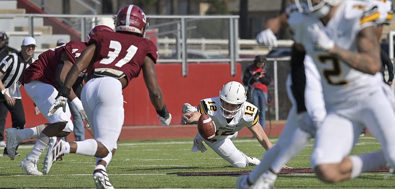 Griffons quarterback Wyatt Steigerwald reaches for a fumbled ball before the Reddies can recover the ball from him at the Agent Barry Live United Bowl at Razorback Stadium on Saturday, December 7, 2019, in Texarkana, Arkansas. The final score of the game was Griffons 35 to Reddies 14. 