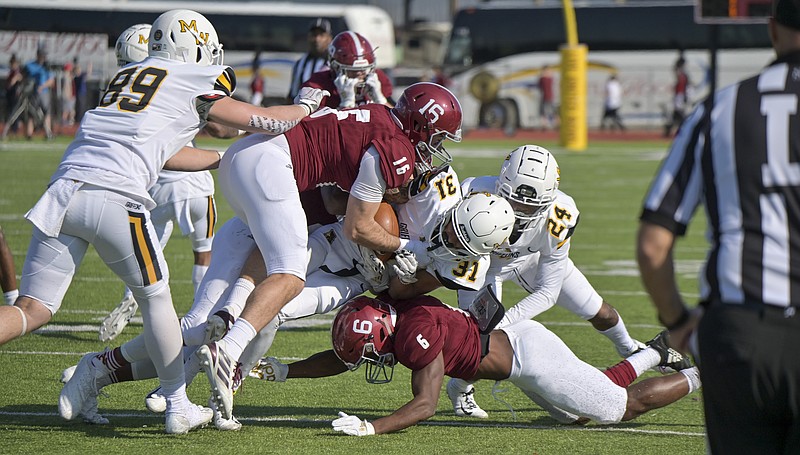 Reddies Kody Whitaker (16) and Landon Cook (6) tackle Griffons Trey Vaval returning a punt at the Agent Barry Live United Bowl at Razorback Stadium on Saturday, December 7, 2019, in Texarkana, Arkansas. 