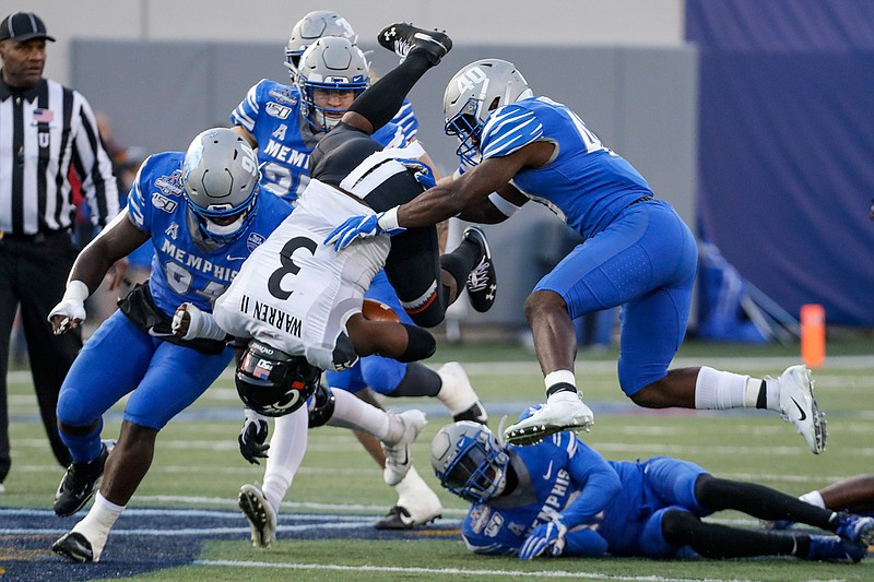 Cincinnati running back Michael Warren II (3) flips as he carries the ball against Memphis during the first half of an NCAA college football game for the American Athletic Conference championship Saturday, Dec. 7, 2019, in Memphis, Tenn. (AP Photo/Mark Humphrey)