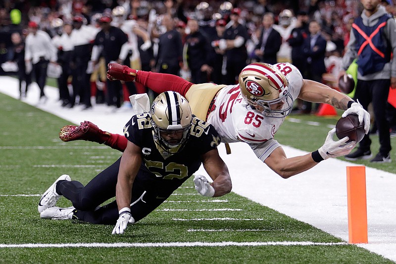 San Francisco 49ers tight end George Kittle (85) dives to the pylon for a touchdown against New Orleans Saints linebacker Craig Robertson (52) in the second half Sunday, Dec. 8, 2019, in New Orleans.