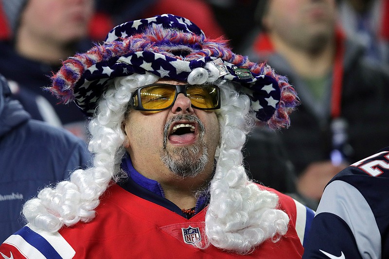 A New England Patriots fan cheers in the second half of an NFL game between the Patriots and the Kansas City Chiefs on Sunday, Dec. 8, 209, in Foxborough, Mass.