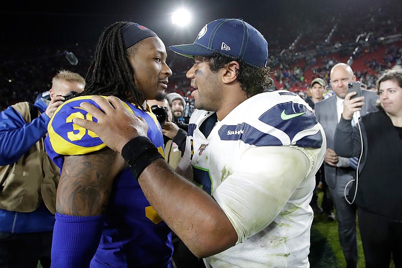 Los Angeles Rams running back Todd Gurley hugs Seattle Seahawks quarterback Russell Wilson after their win in an NFL football game Sunday, Dec. 8, 2019, in Los Angeles. (AP Photo/Marcio Jose Sanchez)