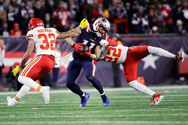 Chiefs safeties Tyrann Mathieu (left) and Juan Thornhill pursue Patriots wide receiver Julian Edelman after a catch during Sunday's game in Foxborough, Mass.