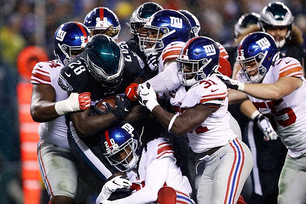 Jay Ajayi of the Eagles is tackled by a host of Giants players during Monday night's game in Philadelphia.