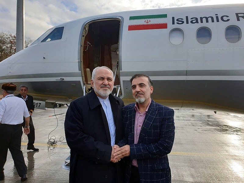 In this photo released on twitter account of Iran's Foreign Minister Mohammad Javad Zarif , Zarif, left, shakes hand with Iranian scientist Massoud Soleimani prior to leaving Zurich, Switzerland for Tehran, Iran, Saturday, Dec. 7, 2019. Iran and the U.S. conducted a prisoner exchange Saturday that saw a detained Princeton scholar released for an Iranian scientist held by America, marking a rare diplomatic breakthrough between Tehran and Washington after months of tensions. (Javad Zarif twitter account via AP)