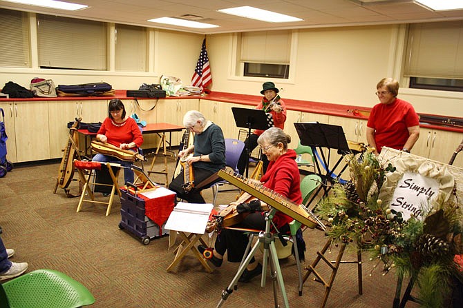 Simply Strings plucked away for a packed house at the Callaway County Public Library on Tuesday evening. Pictured from left in the back are Mary Corderman and Linda Tremain and from left to right in the front are Peggy Kleine, Melanie Black and Carol Welch.