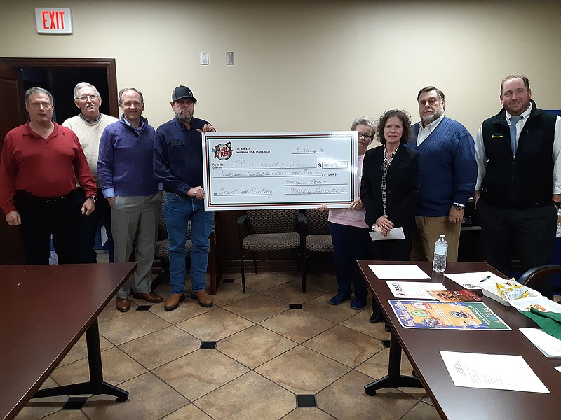 The Main Street Texarkana Board issues a check under the Main Street Texarkana, Arkansas, Grants program to Dennis Pascarella, owner of JP Masonry. The check for $4,700 is a matching amount used to improve the facade of Pascarella's business.
