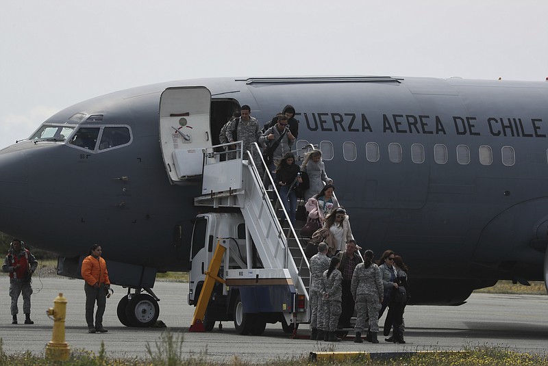 Relatives of passengers of a missing military plane arrive in a Chilean military airplane to an airbase in Punta Arenas, Chile, Wednesday, Dec. 11, 2019. Searchers using planes, ships and satellites were combing the Drake Passage on Tuesday, hunting for the plane carrying 38 people that vanished en route to an Antartica base. (AP Photo/Fernando Llano)