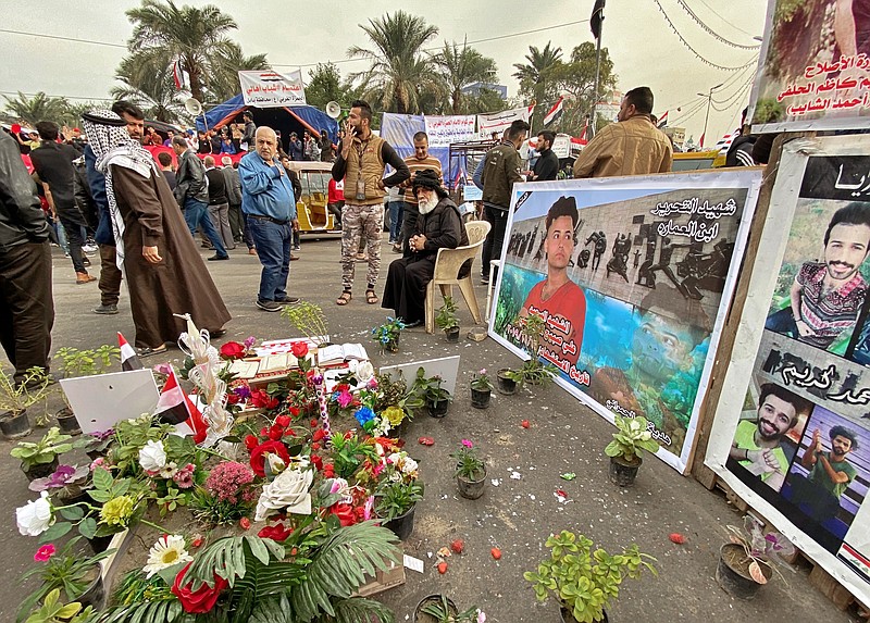Posters of Anti-government protesters who have been killed in demonstrations are displayed in Tahrir Square during ongoing protests in Baghdad, Iraq, Thursday, Dec. 12, 2019.   (AP Photo/Khalid Mohammed)