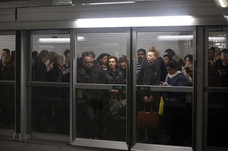 Commuters wait for a metro in the Gare du Nord railway station, in Paris, Thursday, Dec. 12, 2019. France's prime minister said Wednesday the full retirement age will be increased for the country's youngest, but offered a series of concessions in an ill-fated effort to calm a nationwide protest against pension reforms that critics call an erosion of the country's way of life. (AP Photo/Thibault Camus)