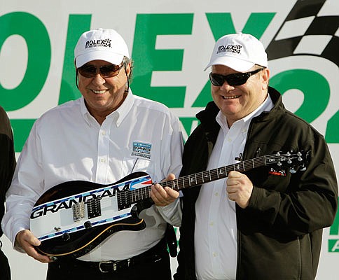 In this Jan. 30, 2011, file photo, car owners Felix Sabates (left) and Chip Ganassi hold a guitar trophy after winning the Grand Am Rolex 24-hour race at Daytona International Speedway in Daytona Beach, Fla.