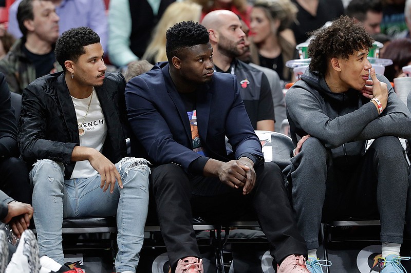 New Orleans Pelicans forward Zion Williamson, center, watches from the bench during the first half of an NBA basketball game against the Miami Heat, Saturday, Nov. 16, 2019, in Miami. (AP Photo/Lynne Sladky)