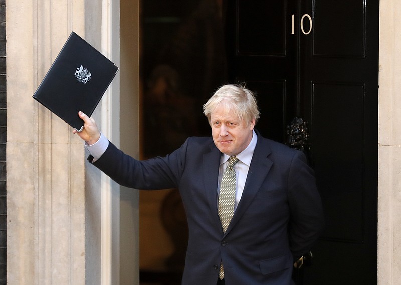 Britain's Prime Minister Boris Johnson waves after addressing the media outside 10 Downing Street in London, Friday, Dec. 13, 2019. Johnson's Conservative Party has won a thumping majority of seats in Britain's Parliament — a decisive outcome to a Brexit-dominated election that should allow Johnson to fulfill his plan to take the U.K. out of the European Union next month.(AP Photo/Frank Augstein)