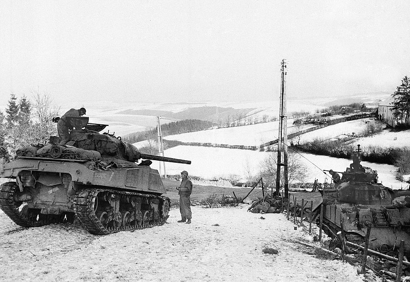 In this Jan. 6, 1945 file photo, American tanks wait on the snowy slopes in Bastogne,Belgium. It was 75 years ago that Hitler launched his last desperate attack to turn the tide for Germany in World War II. At first, German forces drove so deep through the front line in Belgium and Luxembourg that the month-long fighting came to be known as The Battle of the Bulge. When the Germans asked one American commander to surrender, the famous reply came: “Nuts!" By Christmas, American troops had turned the tables on the Germans. Veterans are heading and on Monday, Dec. 16, 2019 when they will mix with royalty and dignitaries to mark perhaps the greatest battle in U.S. military history. (AP Photo, File)