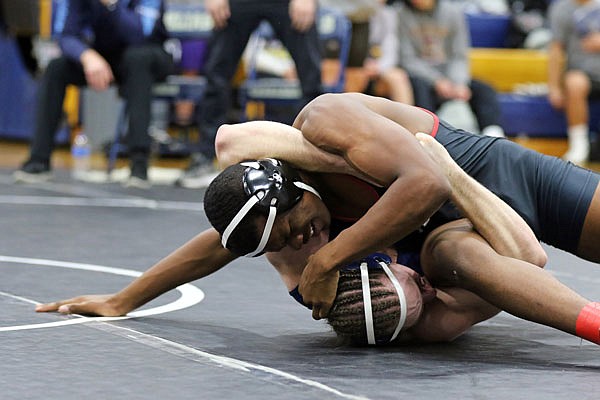 Jakil Hays of the Jays holds down Father Tolton's Conner Fogue to finish off a pin during a 195-pound match Friday in the Missouri Duals at Helias Gym.