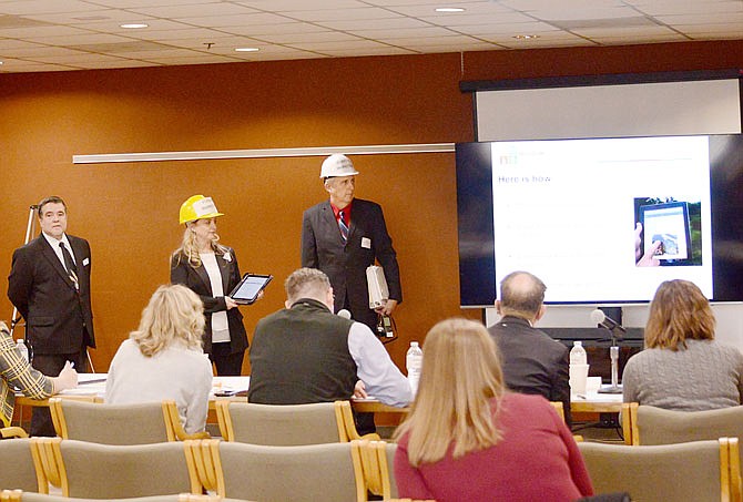 From left, Aaron Forsythe, Tina White and Steve Boone stand in front of judges Friday as they make their proposal for the Department of Natural Resources during the Sow-Me Challenge competition at the Harry S Truman State Office Building. The competition invites Missouri's 16 executive departments to propose their solutions on how to make improvements within the state.