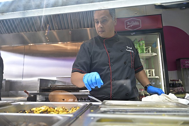 Ehab Moawad, executive chef of Fawah Mediterranean Grill, examines food for the grill on Friday in Texarkana, Texas. The restaurant is inside TCBY on Richmond Road.