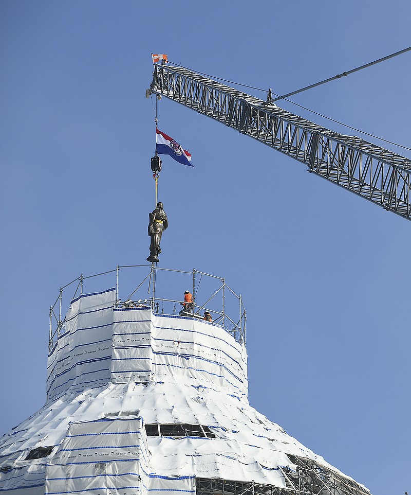 The statue of the Roman goddess Ceres was hoisted back to her perch atop the Missouri State Capitol dome Tuesday, Dec. 17, 2019. 