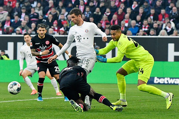 Dusseldorf keeper Zack Steffen (right) keeps an eye on the ball during a scramble near the net during a match last month against FC Bayern Munich in Duesseldorf, Germany.