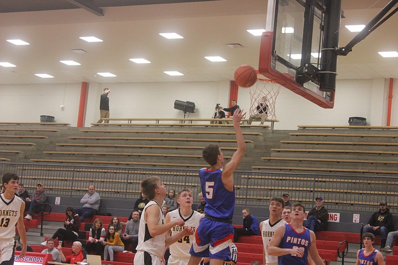 Trevor Porter lays the ball up during the Pintos' loss to St. Elizabeth at the River Region Credit Union Shootout on Dec. 14, 2019.