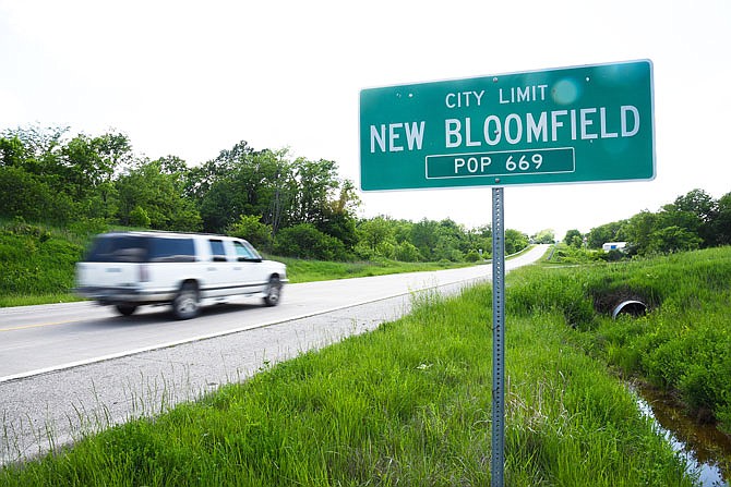 A car moves past the city limit sign for New Bloomfield.