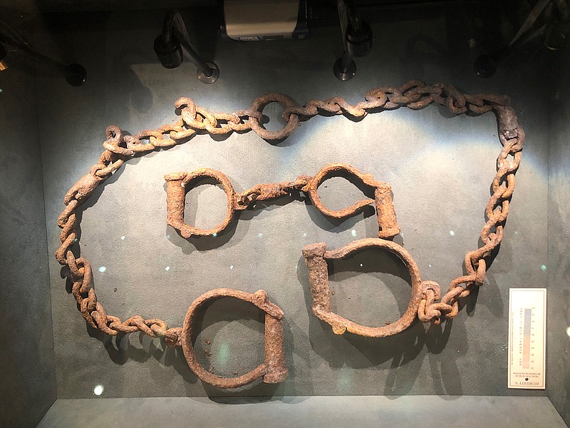 In this Nov. 24, 2019 photo, a set of shackles used to hold enslaved Africans in forts and castles along the coast from Tamale, Ghana, are displayed at the International Slavery Museum in Liverpool, England. The museum seeks to tell the story of the enslavement of people from Africa and how the British city benefited from human bondage. (AP Photo/Russell Contreras)